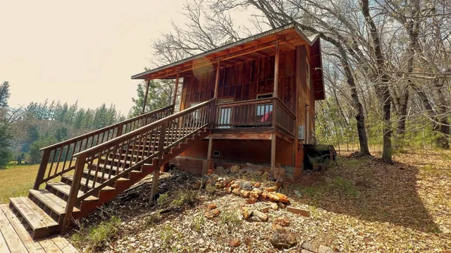 a view of a house with a large window and wooden fence