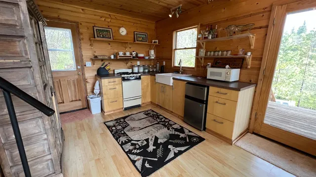 a kitchen with sink refrigerator and window