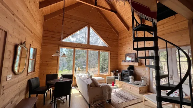 a living room with furniture and a floor to ceiling window