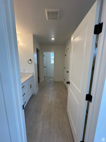 1225 West 500 South Logan, UT 84321 - Photo 33 of 39 Hallway featuring plank tile flooring, recessed lighting, crisp white walls, and white paneled doors with matte black hardware