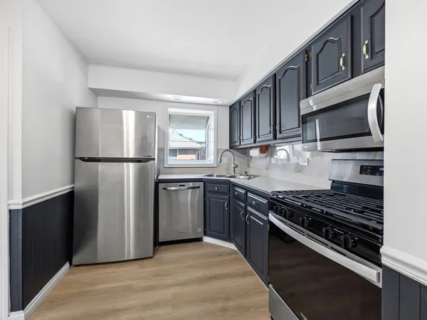 a kitchen with a refrigerator stove and microwave