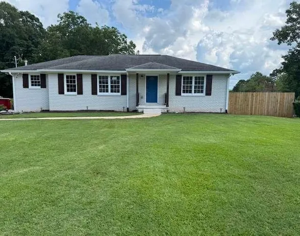 a front view of a house with a garden