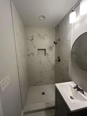 a bathroom with a sink a toilet and mirror