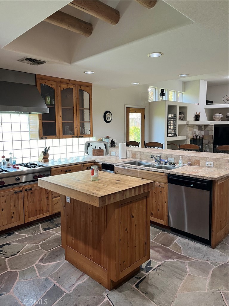 a kitchen with sink stove and cabinets