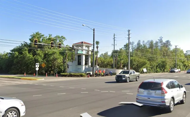 a view of a city street with parked cars