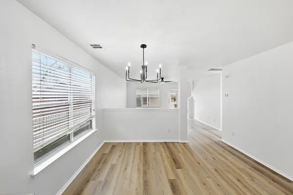 a view of a kitchen with wooden floor and windows