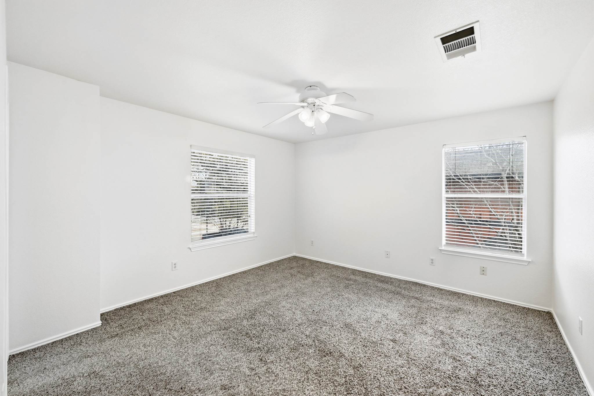 332 Wetzel Kyle, TX 78640 - Photo 14 of 31 an empty room with windows and fan