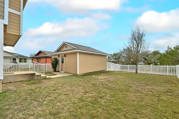 a view of a house with a fence and a garage