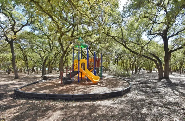 a view of a park with large trees