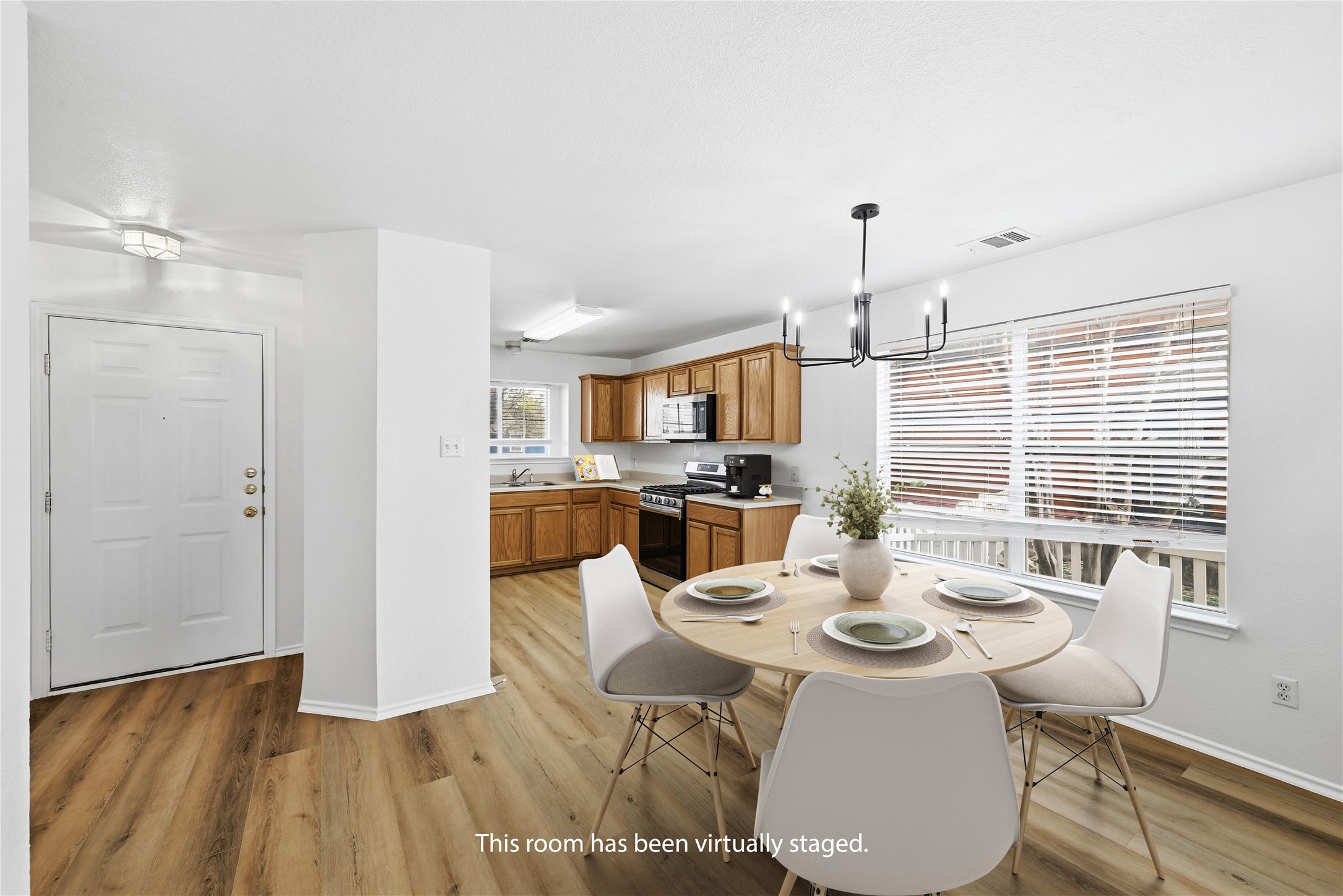 332 Wetzel Kyle, TX 78640 - Photo 9 of 31 a view of a dining room with furniture window and wooden floor