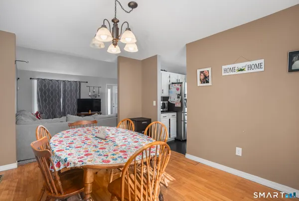 a view of a dining room with furniture and wooden floor