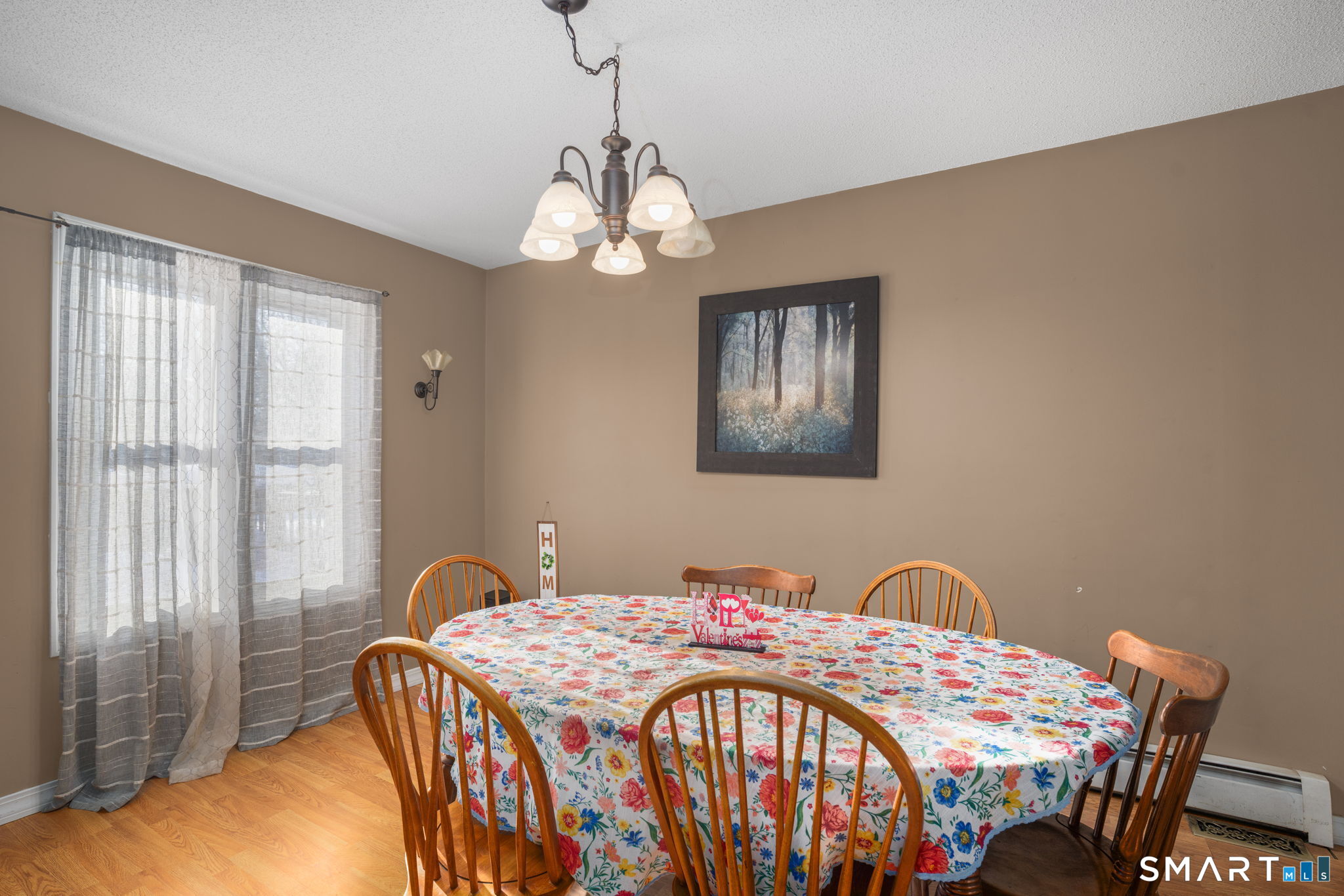 83 Kate Downing Road Plainfield, CT 06374 - Photo 18 of 40 a bedroom with a bed and a chandelier