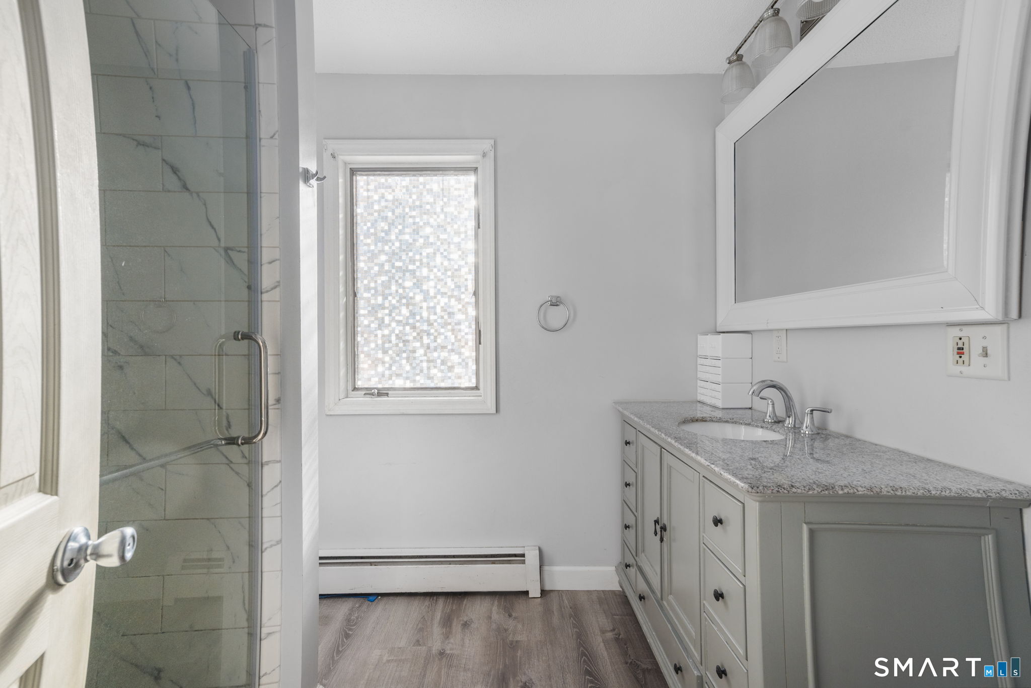 83 Kate Downing Road Plainfield, CT 06374 - Photo 28 of 40 a bathroom with a granite countertop sink a mirror and a shower