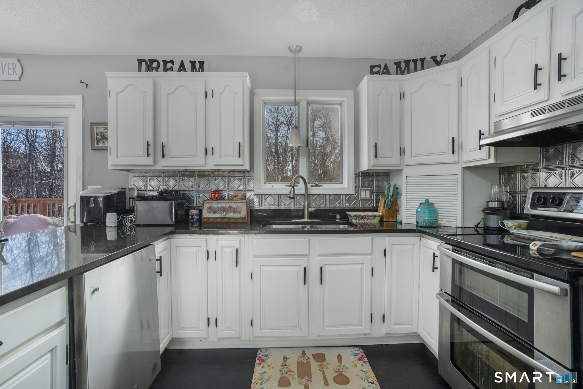 83 Kate Downing Road Plainfield, CT 06374 - Photo 3 of 40 a kitchen with stainless steel appliances granite countertop a stove a sink and white cabinets