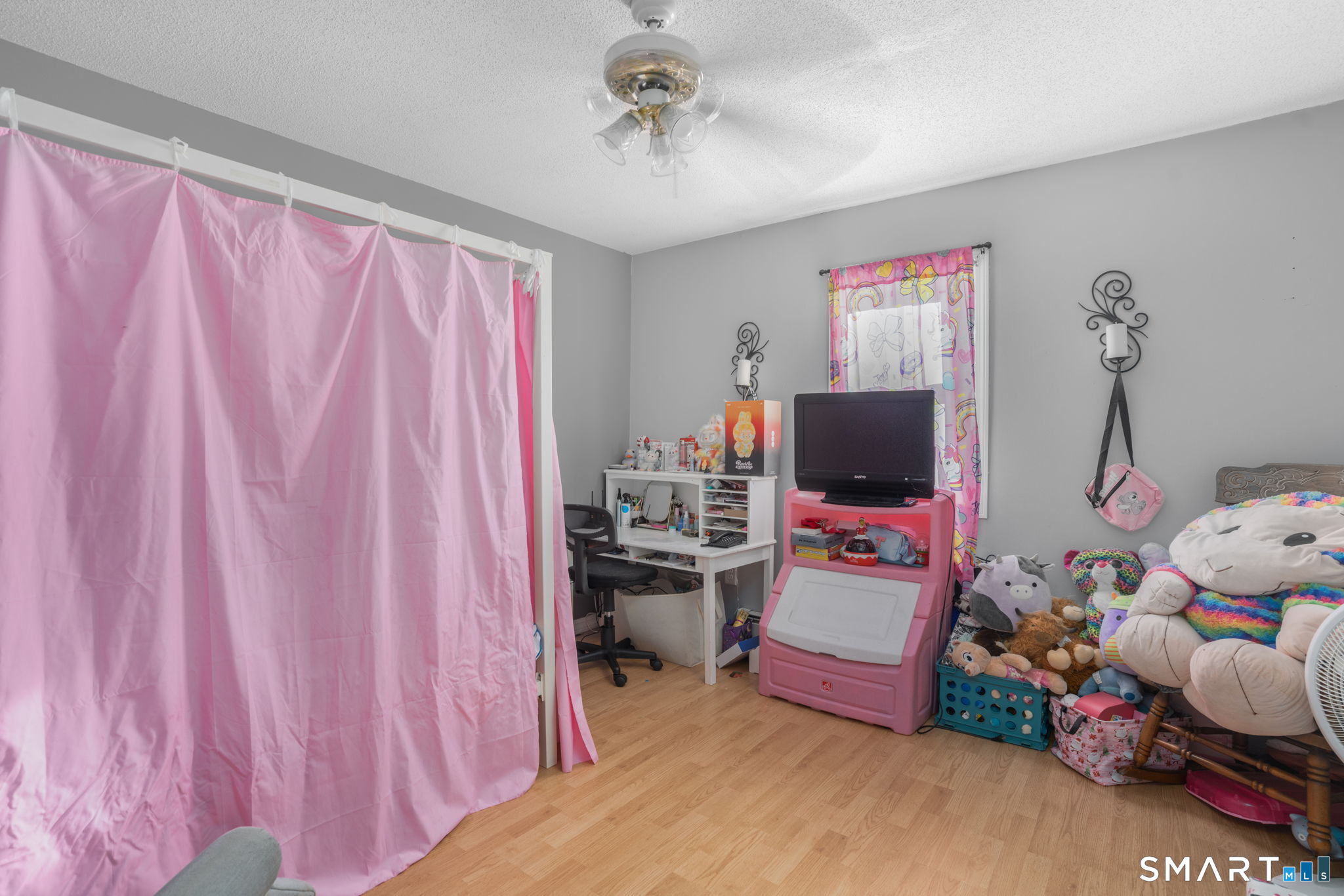 83 Kate Downing Road Plainfield, CT 06374 - Photo 39 of 40 a bedroom with a bed and a chandelier