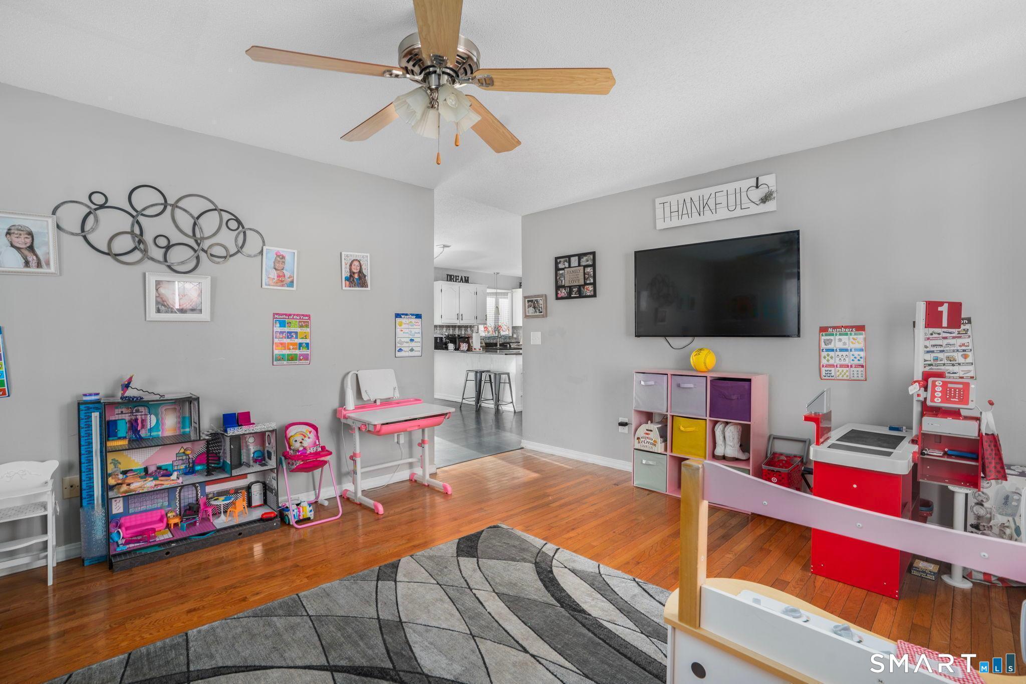 83 Kate Downing Road Plainfield, CT 06374 - Photo 40 of 40 a bedroom with furniture and a flat screen tv