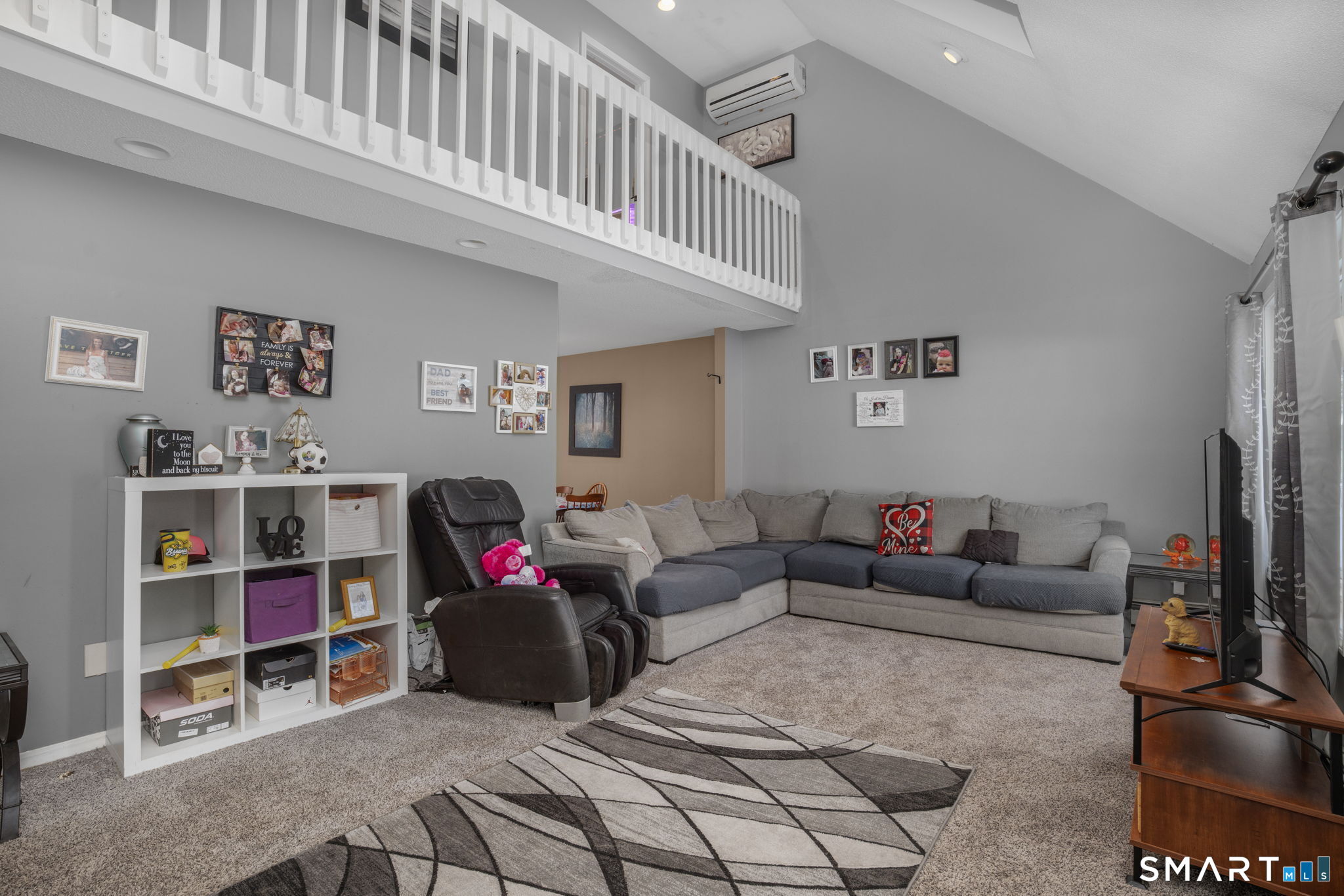 83 Kate Downing Road Plainfield, CT 06374 - Photo 7 of 40 a living room with furniture and a book shelf