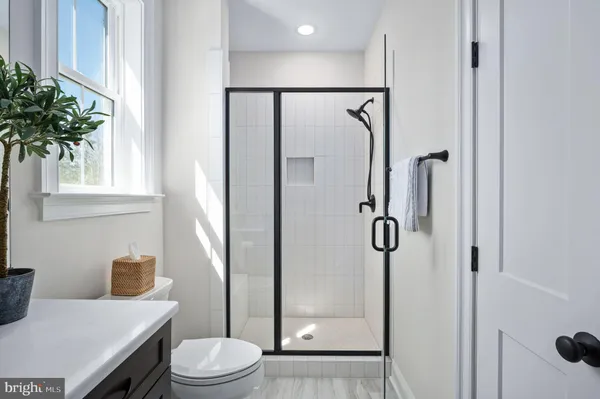 a bedroom with a bed couch and window