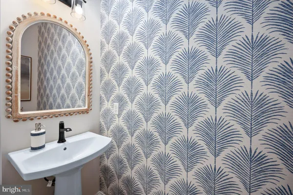 a bathroom with a tub sink and mirror