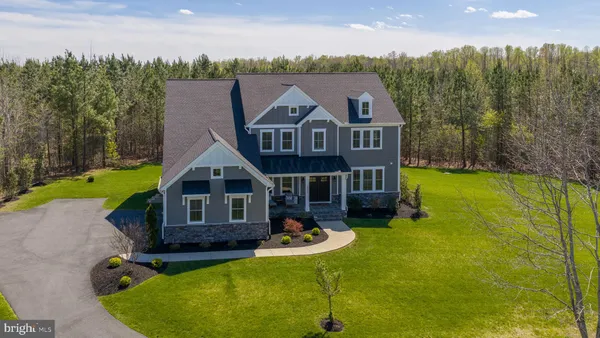a aerial view of a house with swimming pool next to a yard