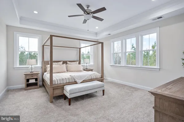 a living room with a bed furniture and a window