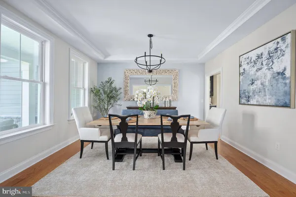 a dining room with furniture window and wooden floor