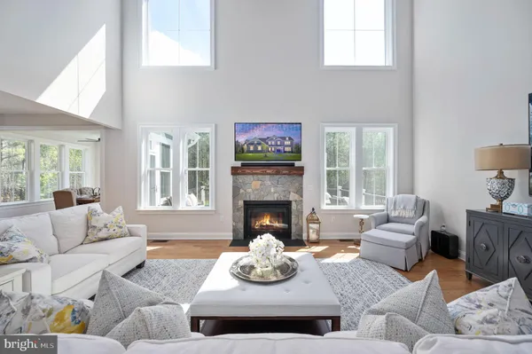 a living room with furniture fireplace and window