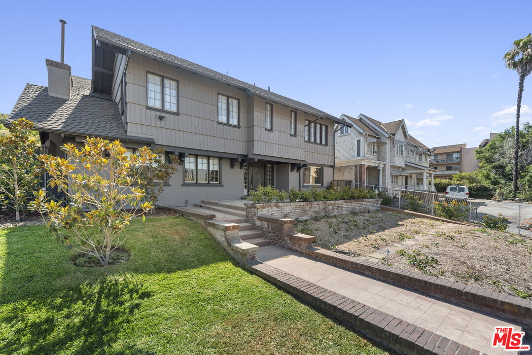 a front view of a house with garden