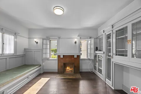 a view of a kitchen with a refrigerator a stove top oven and cabinets