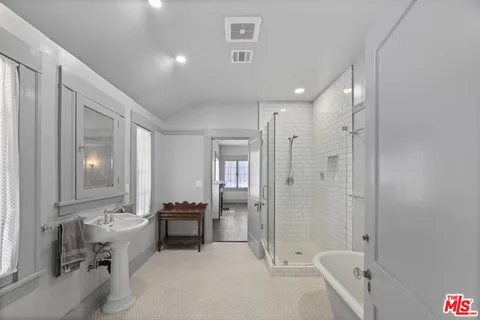 a spacious bathroom with a bathtub shower and toilet