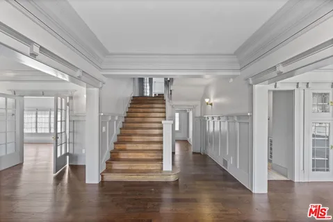 a view of an entryway with wooden floor
