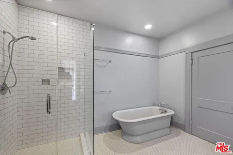 a bathroom with a white toilet and shower