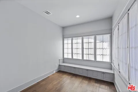 a view of room with window and hardwood floor