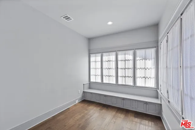 a view of room with window and hardwood floor