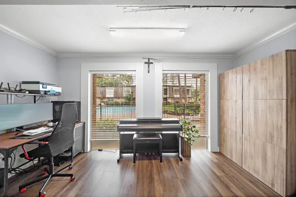 a workspace with wooden floor and a window
