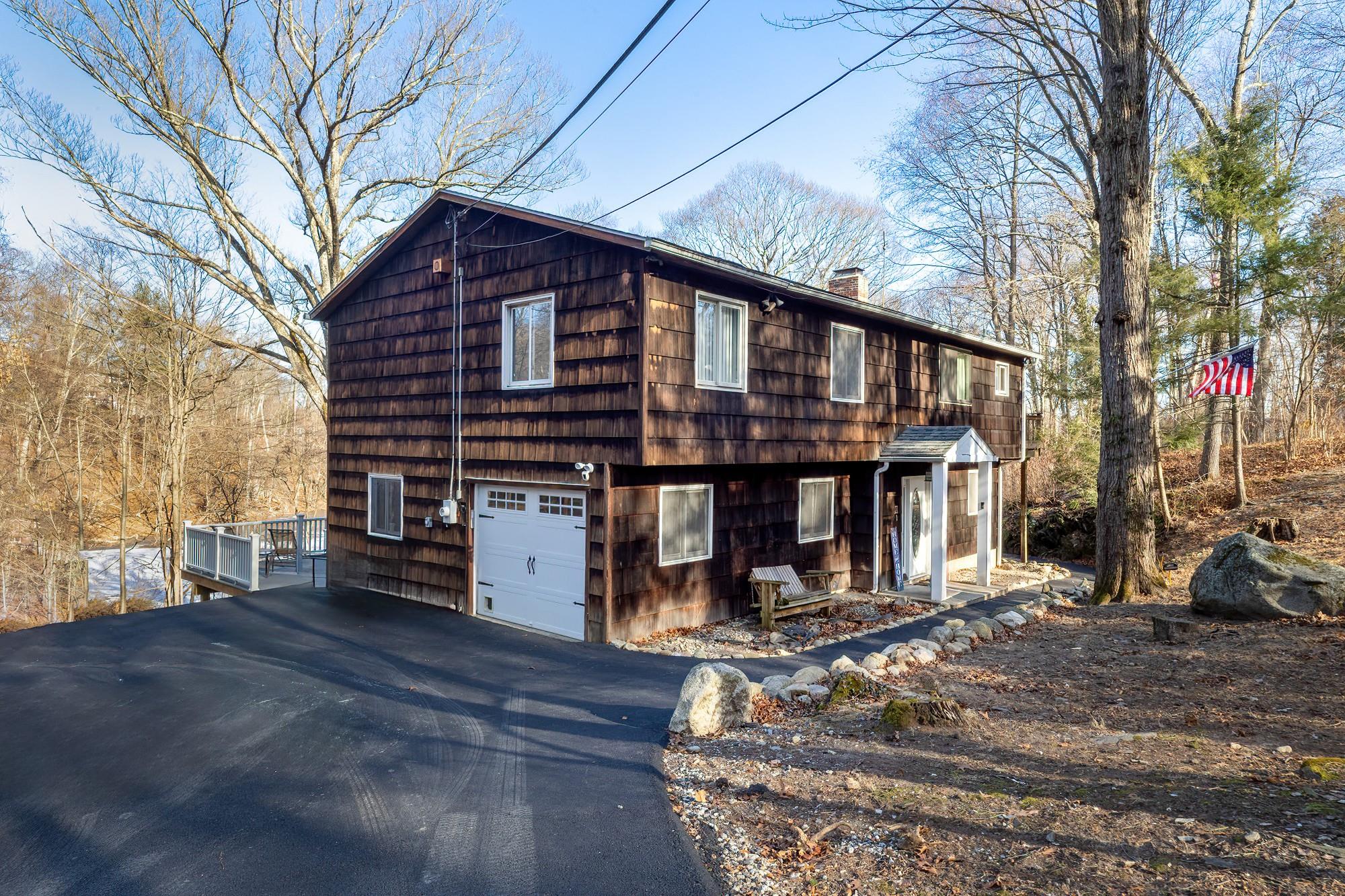 a view of a house with a wooden deck