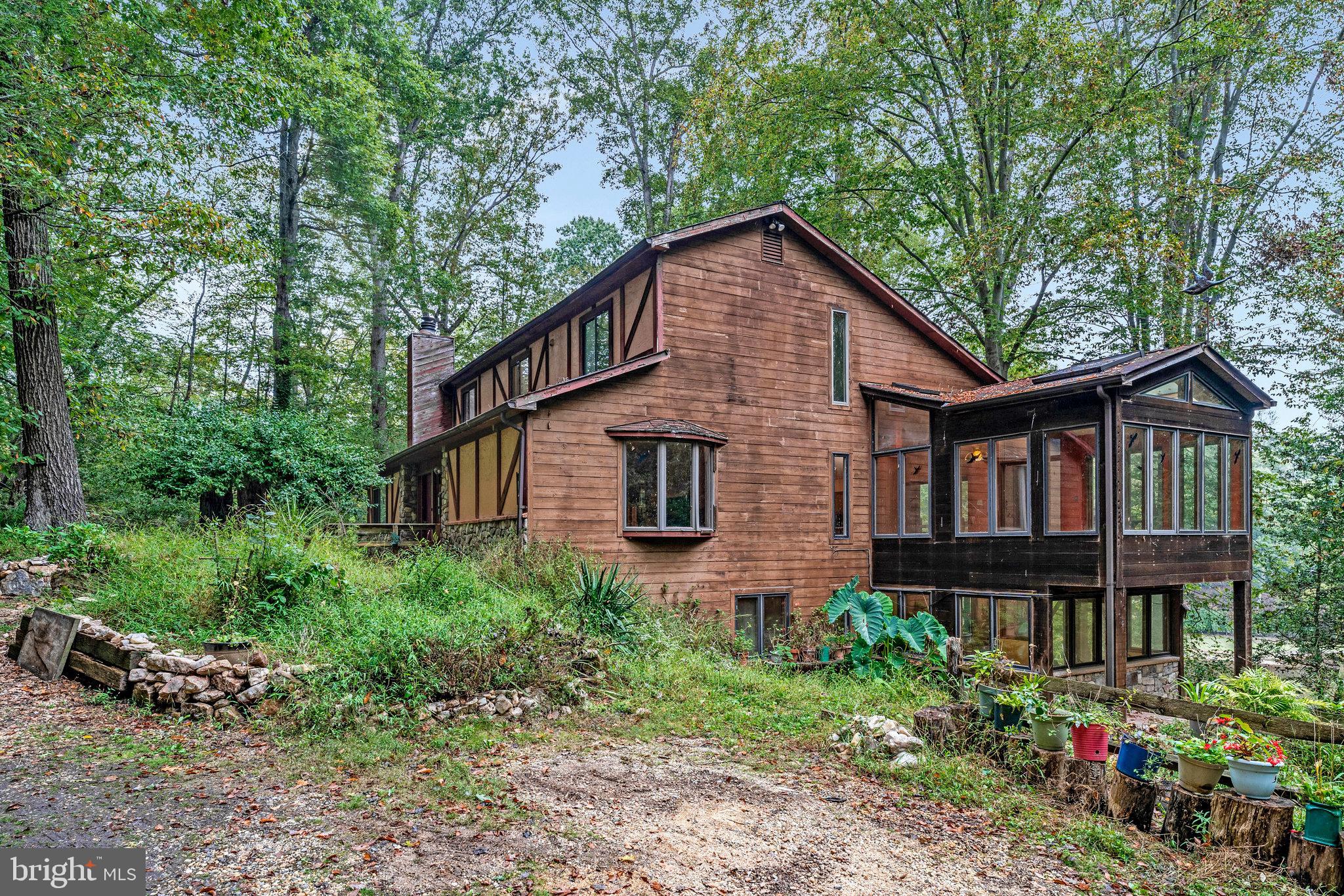 10400 Hampton Road Fairfax Station, VA 22039 - Photo 12 of 53 a brick house with lots of flower plants in front of it