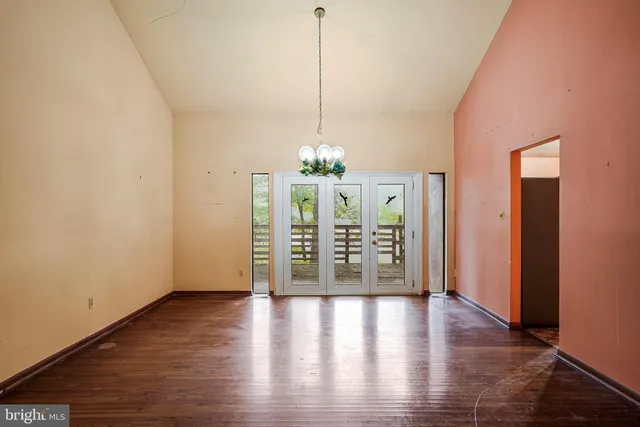 a view of a room with wooden floor