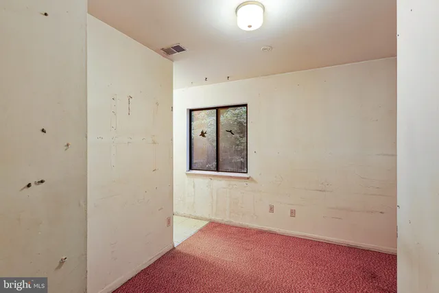 a view of a kitchen with a sink and dishwasher a refrigerator with white cabinets