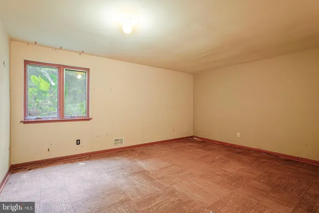 a living room with furniture and large windows