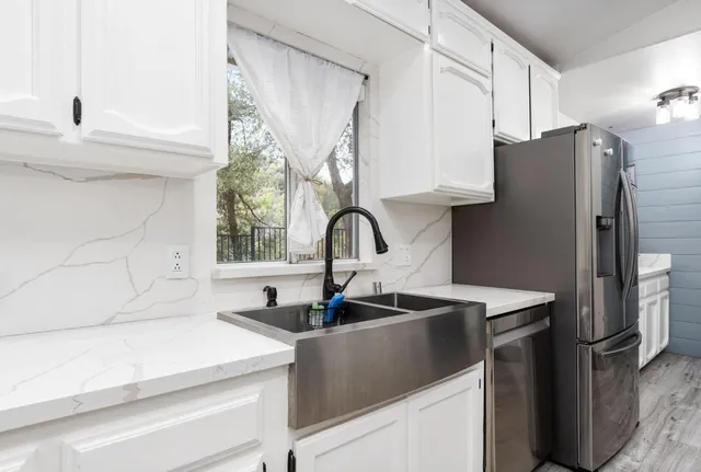 a close view of a sink and a refrigerator