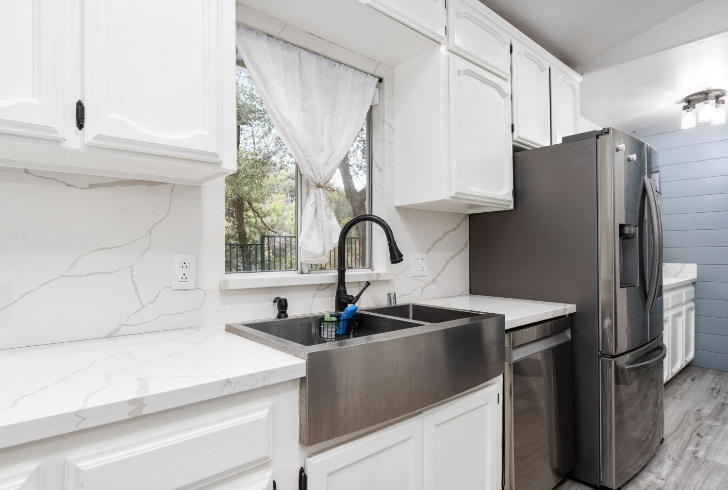 36345 Mudge Ranch Road Coarsegold, CA 93614 - Photo 12 of 51 a close view of a sink and a refrigerator