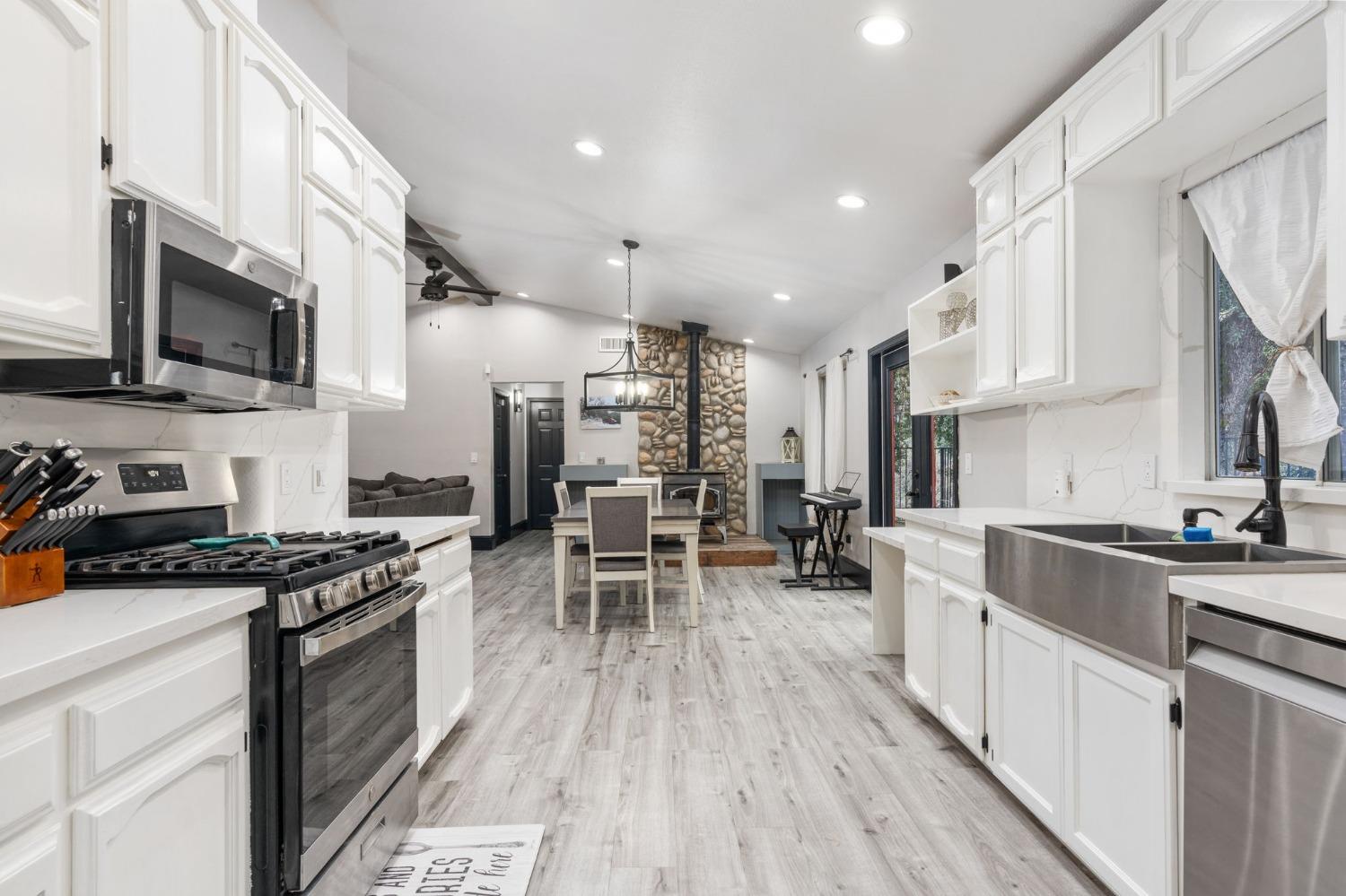 36345 Mudge Ranch Road Coarsegold, CA 93614 - Photo 14 of 51 a kitchen with stainless steel appliances a stove sink microwave and cabinets