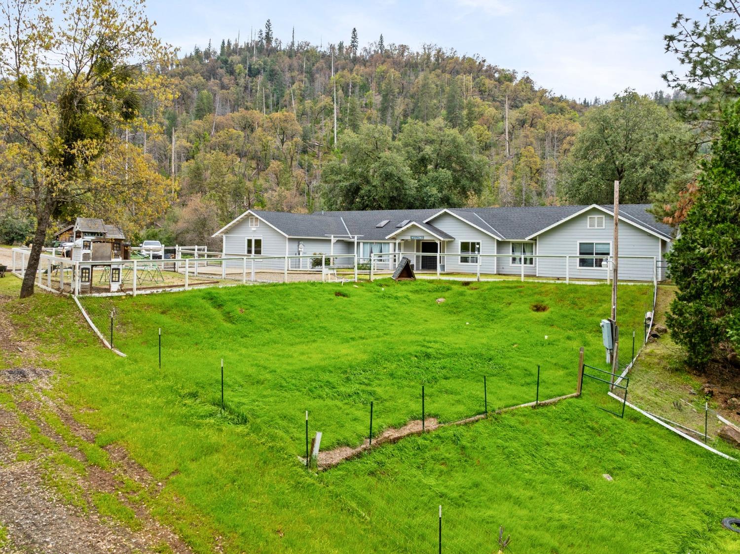 36345 Mudge Ranch Road Coarsegold, CA 93614 - Photo 2 of 51 an aerial view of residential houses with outdoor space and trees