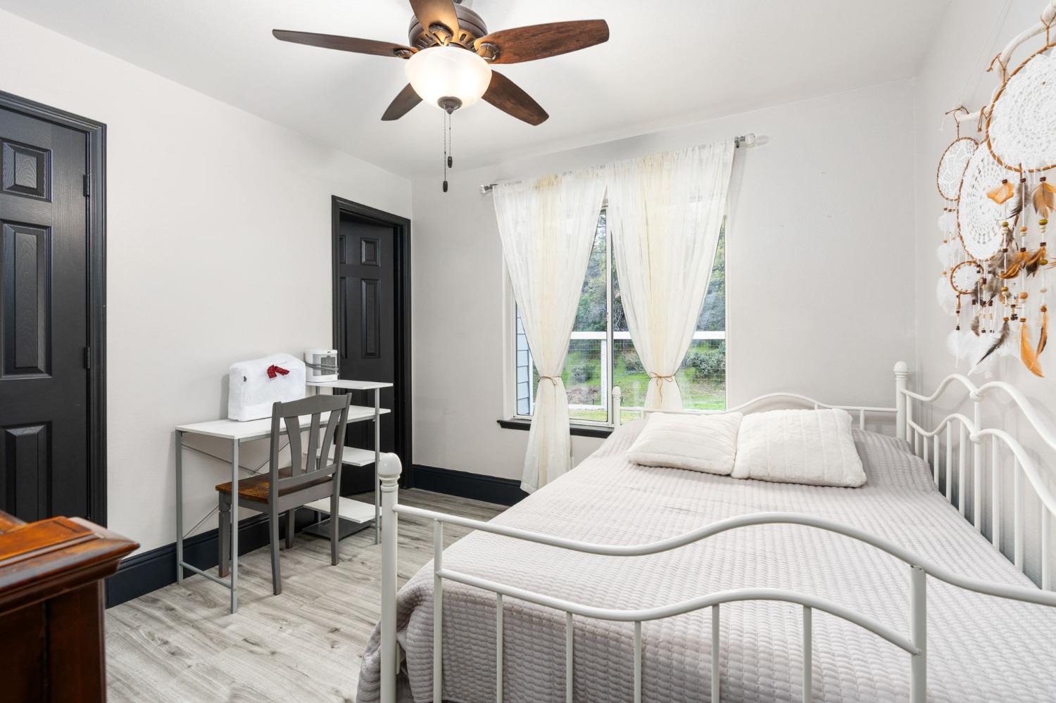 36345 Mudge Ranch Road Coarsegold, CA 93614 - Photo 21 of 51 a bedroom with a bed and a table in it