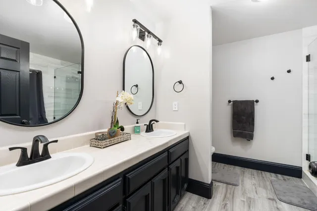 a bathroom with a double vanity sink and a mirror