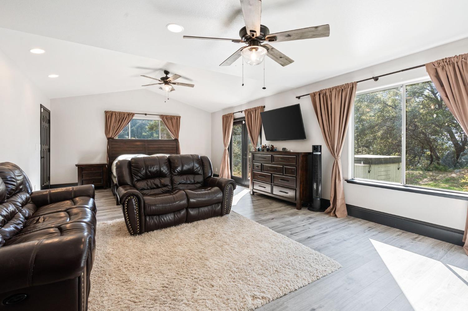 36345 Mudge Ranch Road Coarsegold, CA 93614 - Photo 29 of 51 a living room with furniture a flat screen tv and a large window