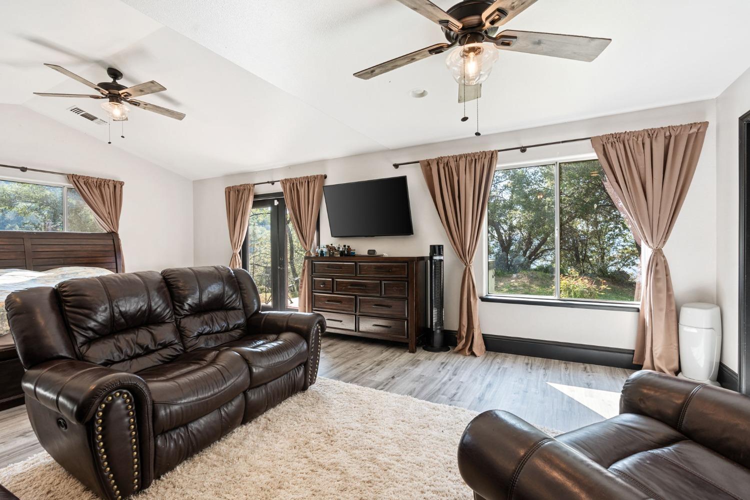 36345 Mudge Ranch Road Coarsegold, CA 93614 - Photo 31 of 51 a living room with furniture a ceiling fan and a wooden floor