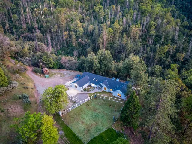 an aerial view of a house with a yard