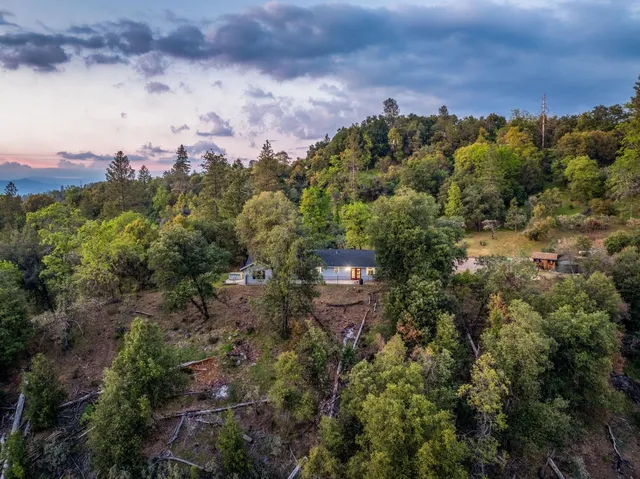 an aerial view of a house with a yard